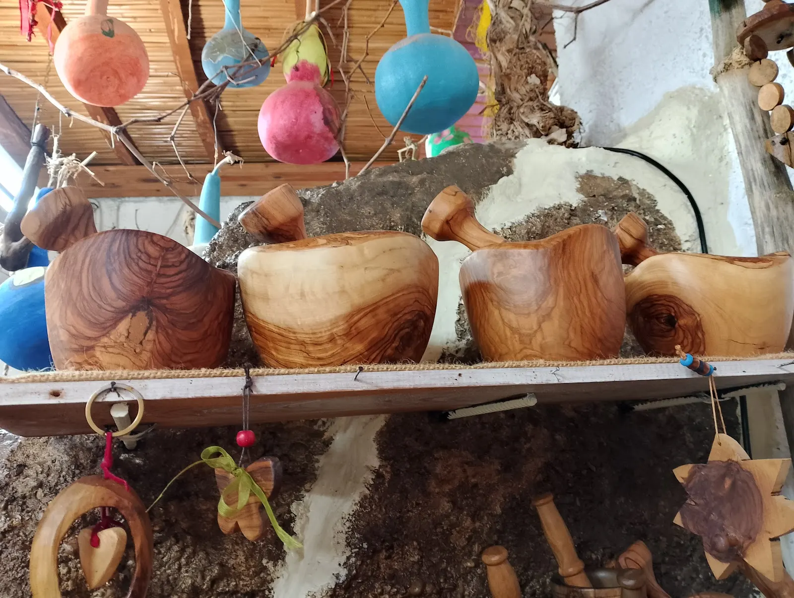 Bowls on a shelf with hanging decorations